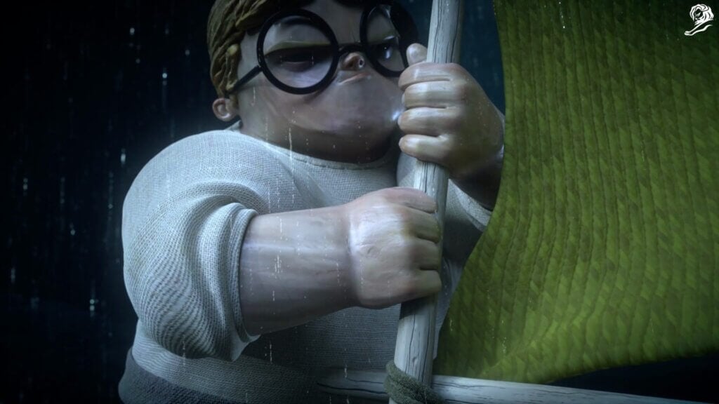 Animated character with glasses and a sweater tightly gripping a pole in the rain, with a green object in the background—a scene inspired by winning campaigns at Cannes and the creative spirit of Klick Health.