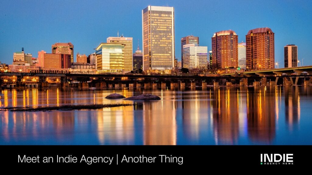 City skyline reflected on a calm river at dusk, with illuminated buildings and a bridge; text overlay reads, Meet an Indie Agency | Another Thing. Everyone has the same tools, but different wins shape every unique city story.