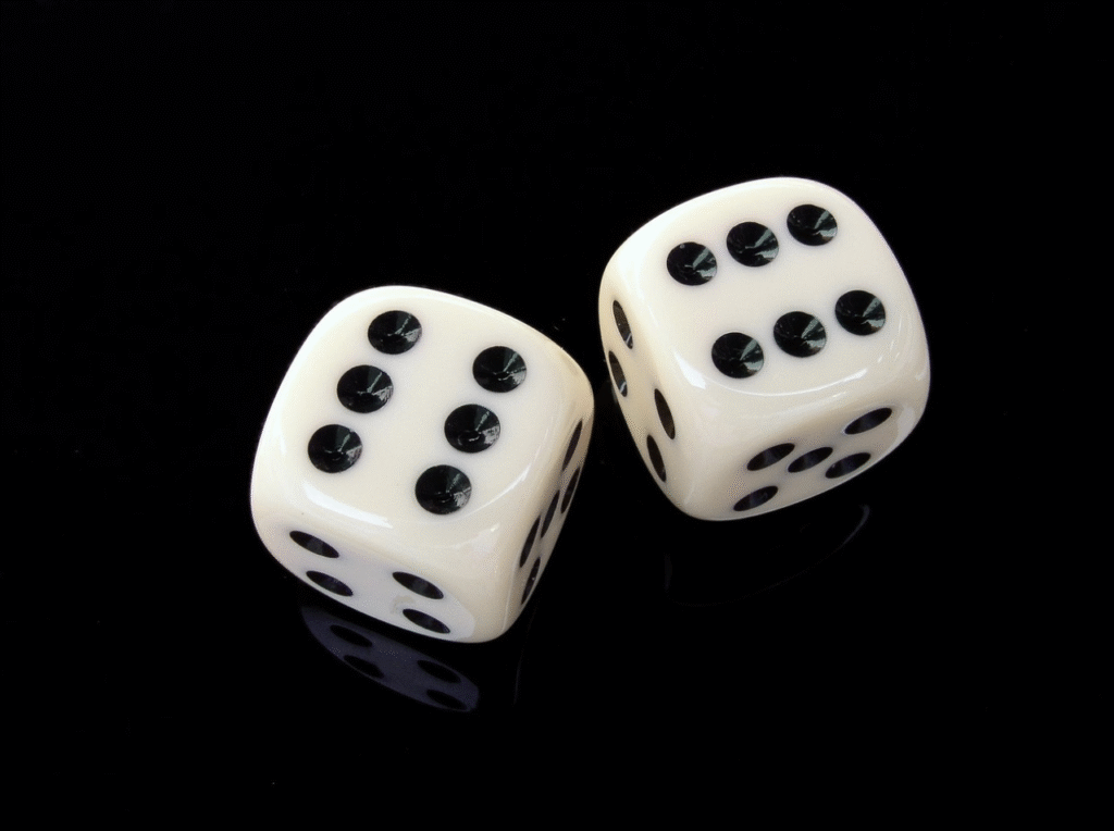 Two white dice with black dots showing six and five, placed on a reflective black surface.
