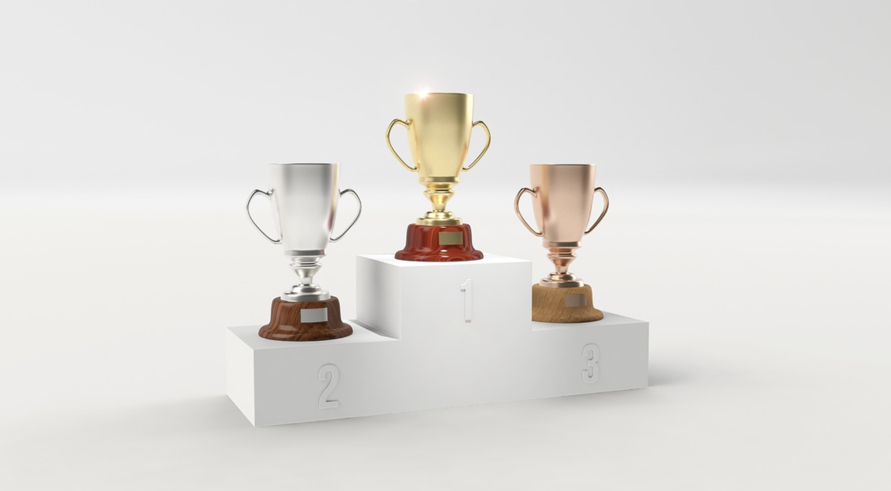 Three trophies—gold, silver, and bronze—are displayed on a white podium labeled 1, 2, and 3, signifying first, second, and third place awards—a scene reminiscent of the competitive spirit found in indie games.