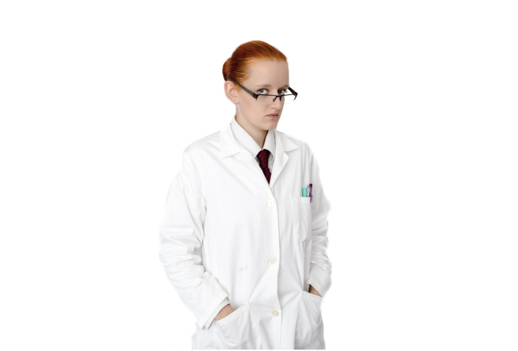 Person in a white lab coat and glasses stands with hands in pockets, looking slightly to the side against a white background—exuding the calm confidence of a true Lab Coat Trophy winner and embodying the curiosity of a devoted DevOps Rookie.