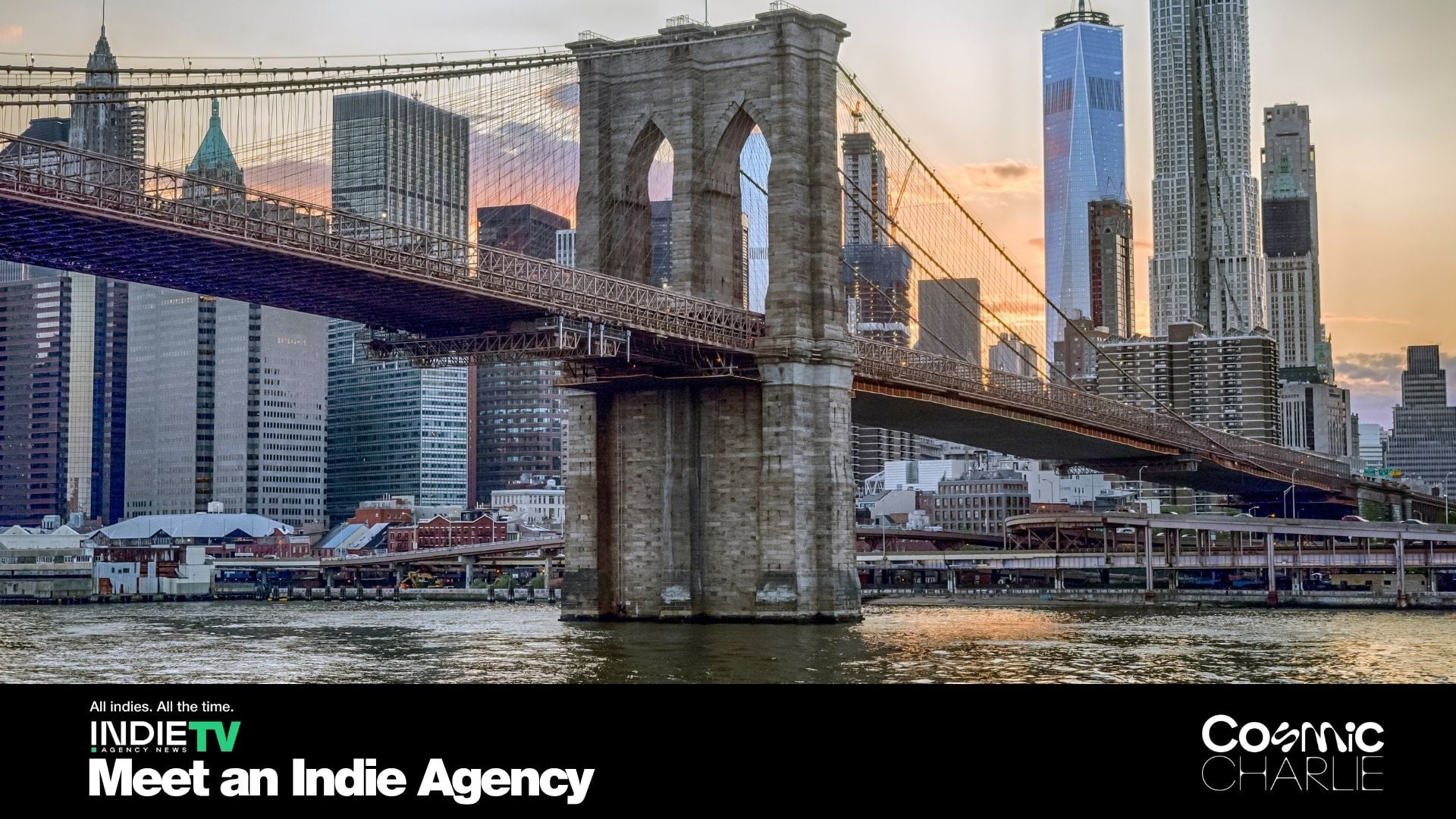 The Brooklyn Bridge spans the East River at sunset with Manhattan skyscrapers in the background. Promotional text for Indie TV and Cosmic Charlie overlays the bottom of the image.