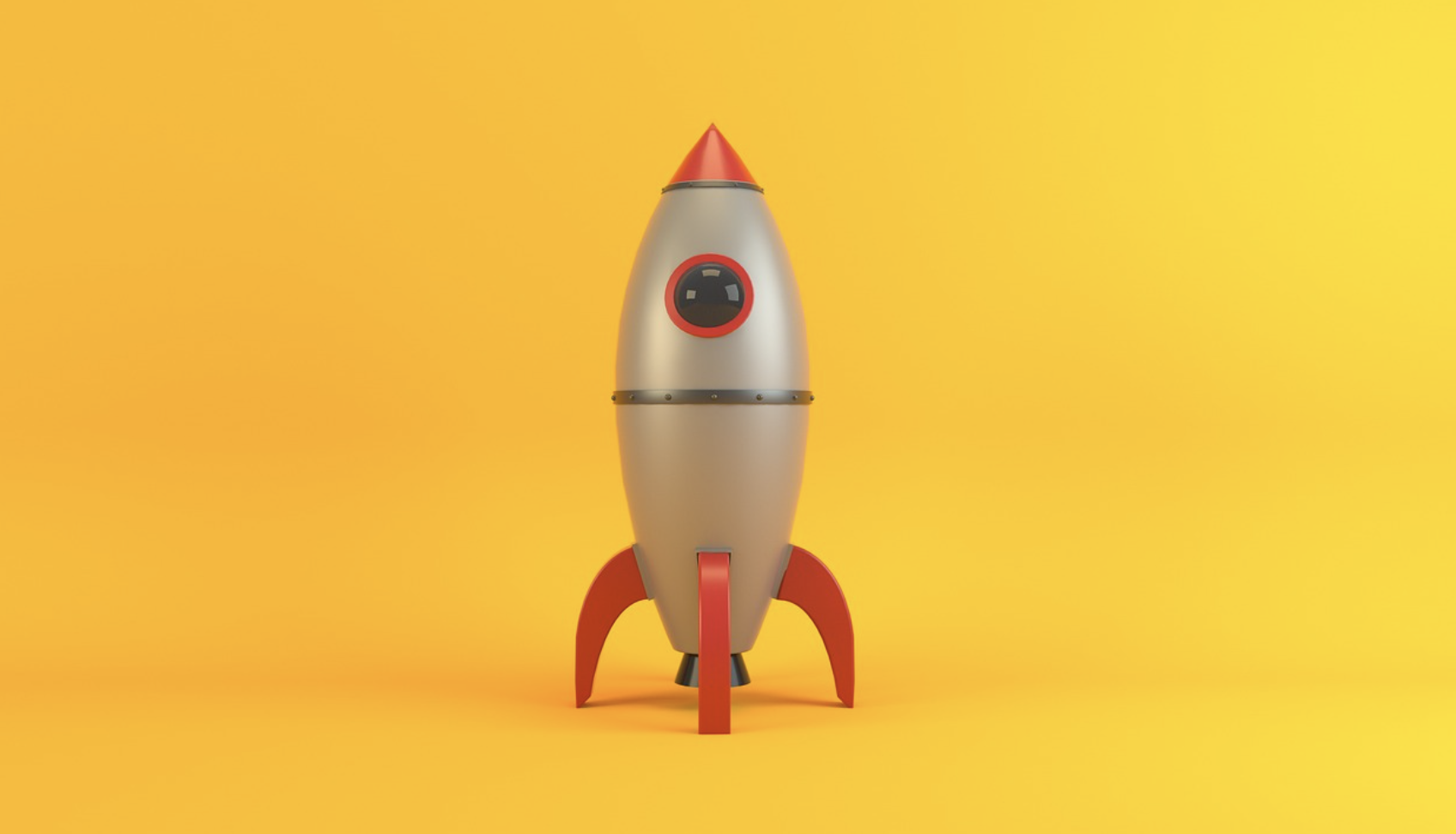 A cartoon-style rocket ship with red fins and a round window stands upright against a bright yellow background.
